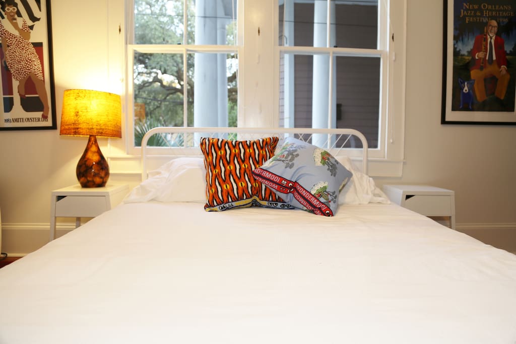 Foot of bed with lots of beautiful light from the windows.