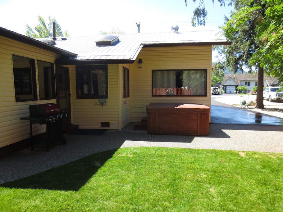 concrete patio area with bbq and hot tub