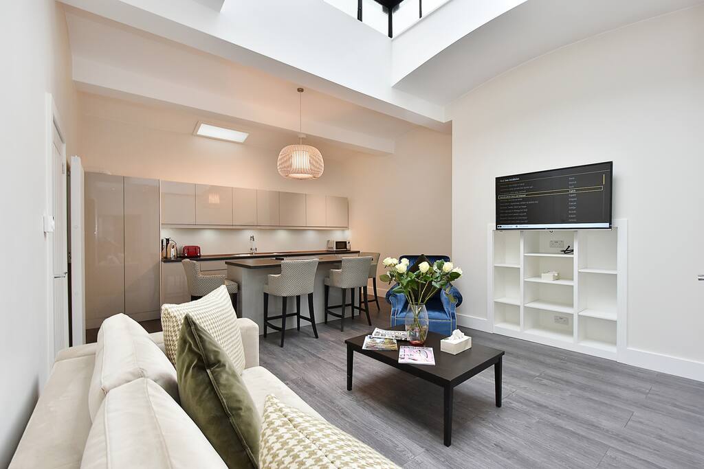 The bright, luxuriously furnished, new Lounge, dining area and kitchen with large Smart TV