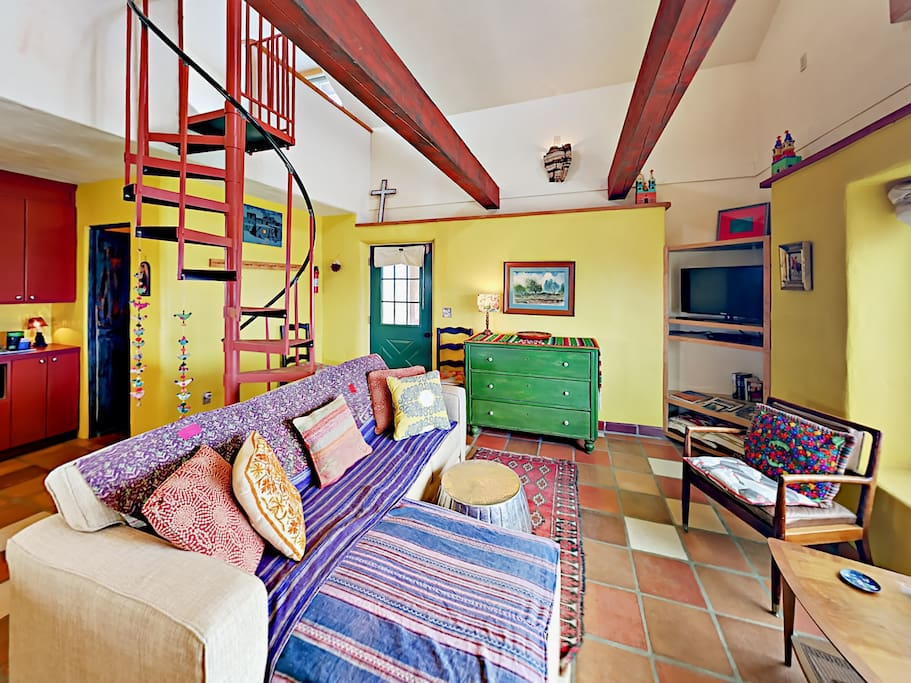 High ceilings and colorful Southwestern decor create a welcoming vibe throughout this rental.