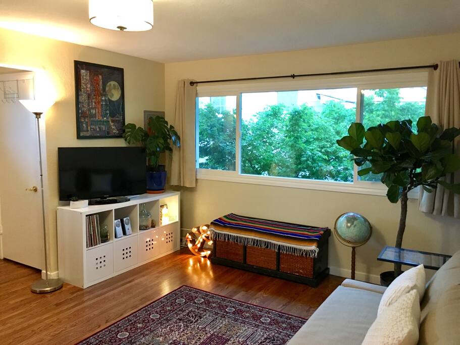 Living room. TV and extra seating by the window.