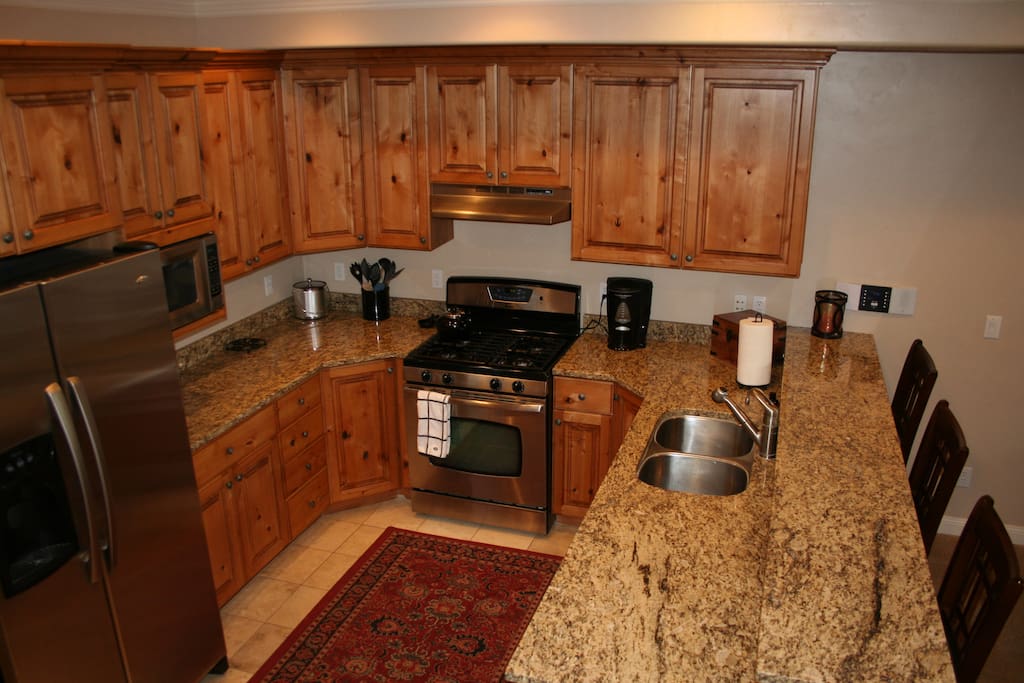 Kitchen with granite countertops, well stocked for cooking