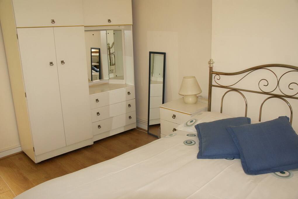 Large cupboard for use and mirror. Lamp and bedside draws