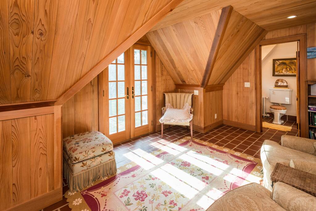 loft with balcony off of bedroom.