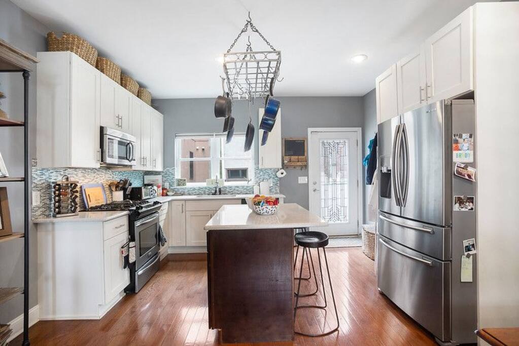 Kitchen with island and access to outdoor area.
