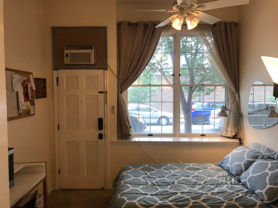 Facing the main entrance (Ceiling fan above the bed and Air Conditioner)