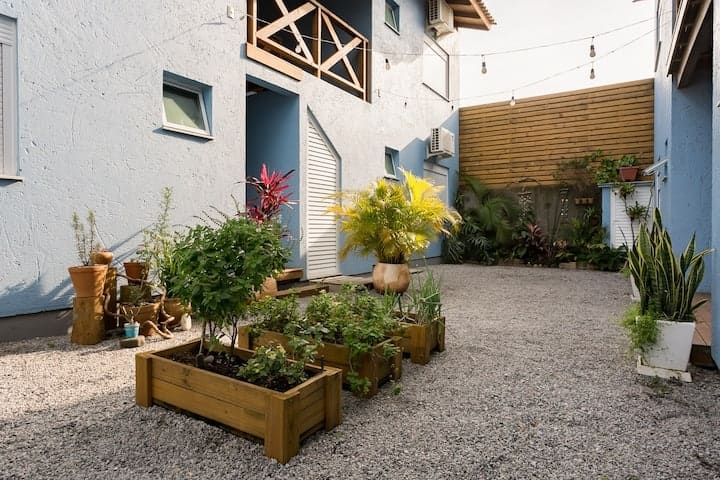 Área entre las casas adosadas, con camas de especias y hierbas. Depósito para lavar.