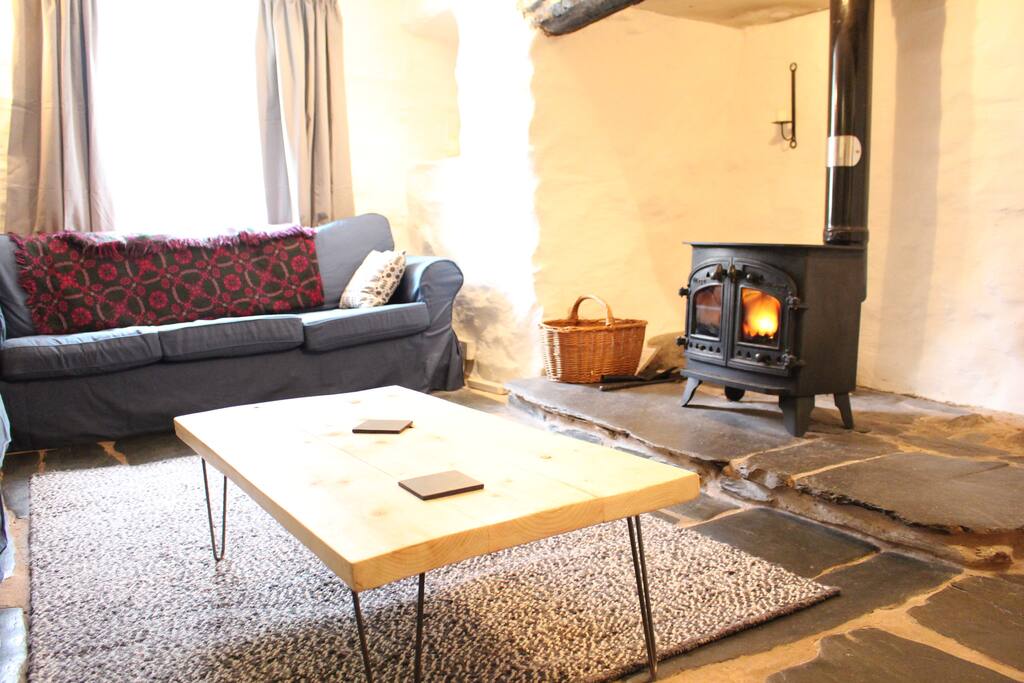 Living room with wood burner in inglenook fireplace