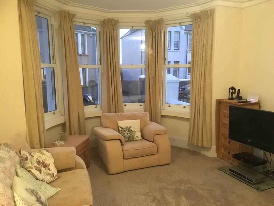 The living room with a tv streaming sky movies and other iplayers. A selection of board games are available.
