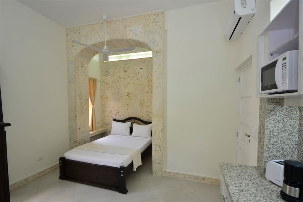 View of bed in travertine archway