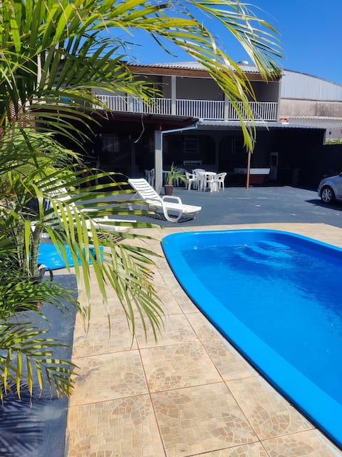 House with pool, barbecue area, and parking.