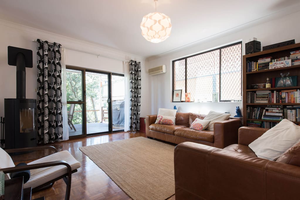 Light and bright living room. Sliding doors onto leafy deck. Always cool in summer and the wood fire makes for cosy winter evenings.