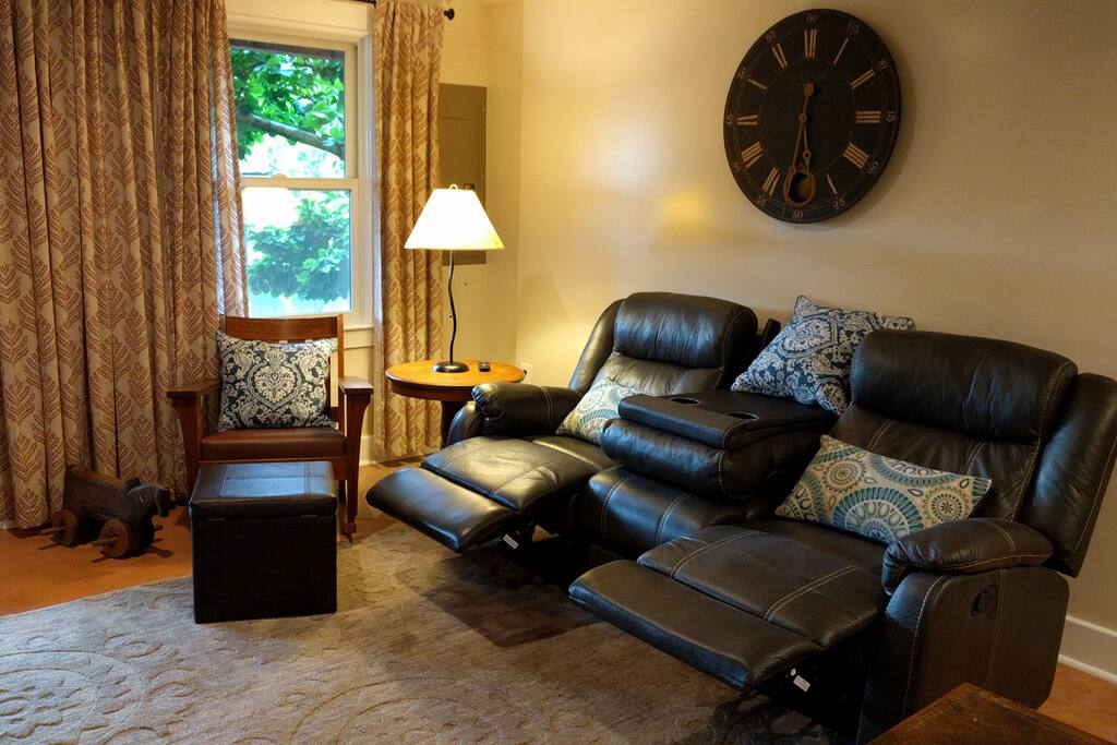 Couch turns into two recliner chairs, middle folds down with cup holders.