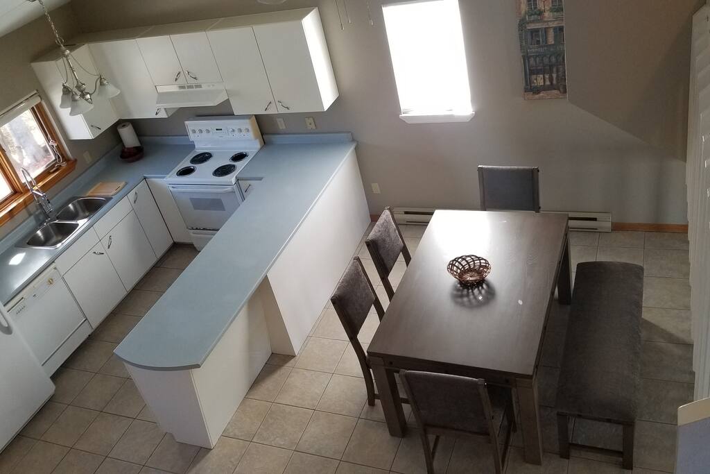 Open concept cathedral ceiling kitchen/dining room.