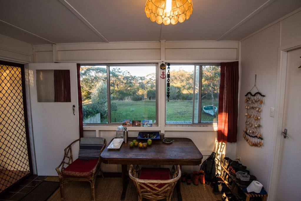 Enter the apartment through the sunroom with views of the backyard
