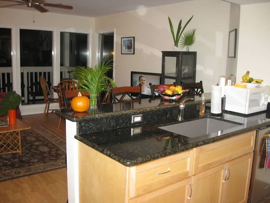 Granite throughout kitchen. Kitchen over looks livingroom area.
