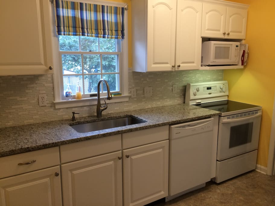 Kitchen with granite and tile backsplash