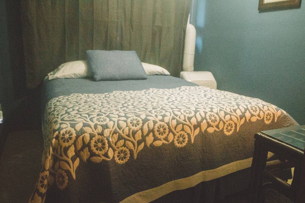 Queen bed an AC unit