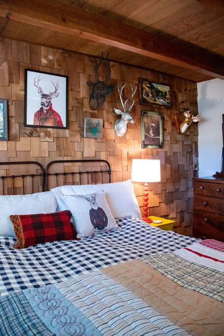 Queen bed in the OH DEER! room downstairs
