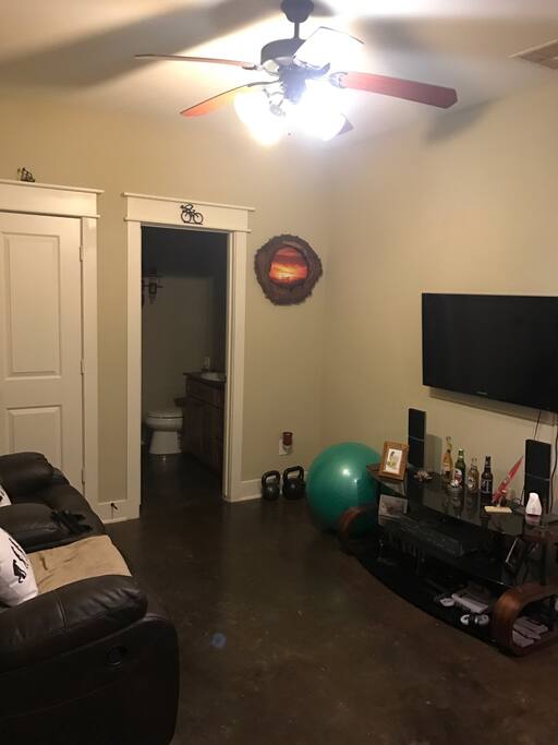 Downstairs bedroom features sofa + plenty of room for air mattress as well as full bath