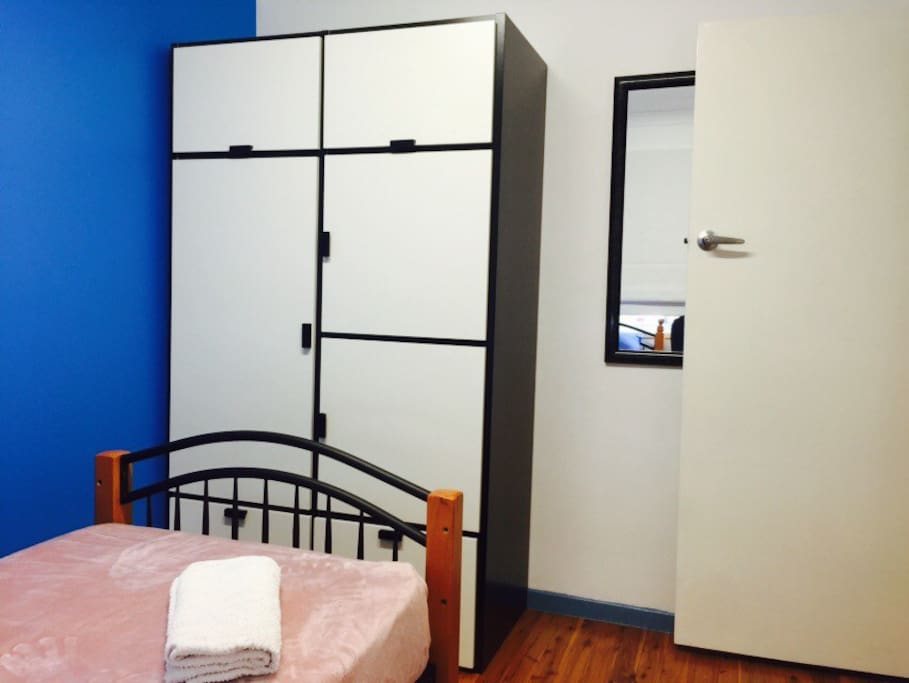 Excellent cupboard space and large mirror in your private room.