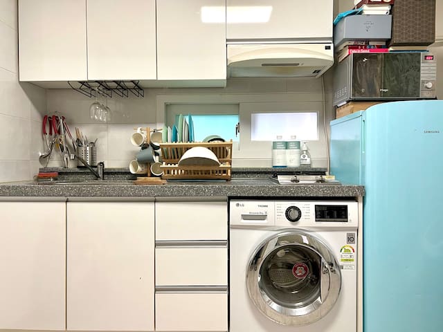 Kitchen with Washing Machine and fridge, Micro wave Oven