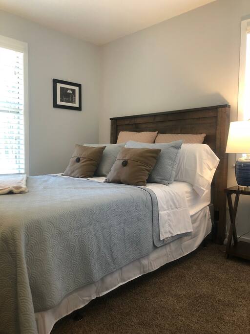 Bedroom 2 - relax and rest in a comfortable queen size bed with amenities that include flat screen TV, night stand, dresser, and closet.