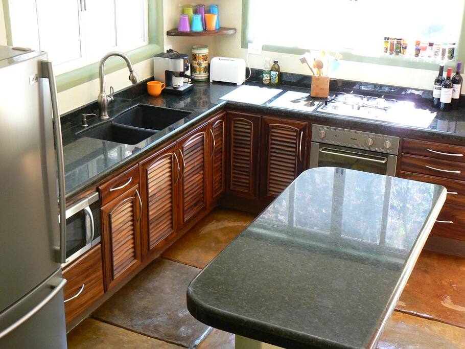 Kitchen w/ granite countertops and beautiful wood cabinets