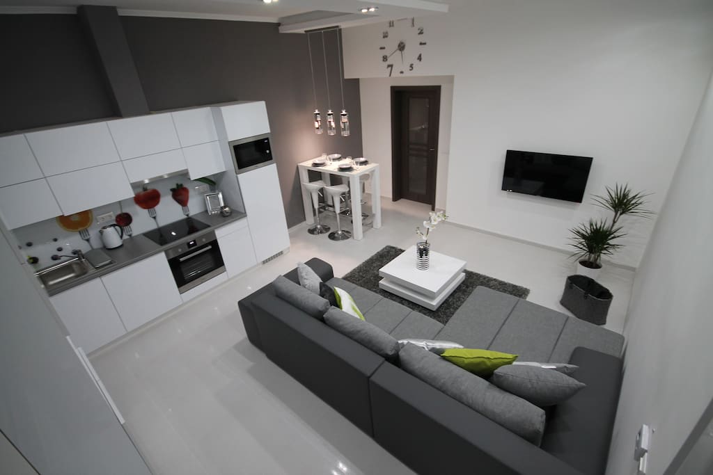 Open-air living room with kitchen. This big bed is comfortable for two people ( if we turn it to a bed 200x180 cm )