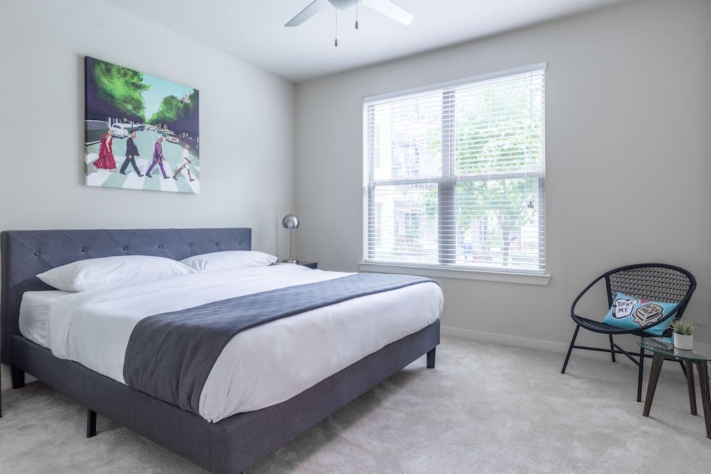 Spacious bedroom with a King bed and memory foam mattress, nightstands with USB connectors