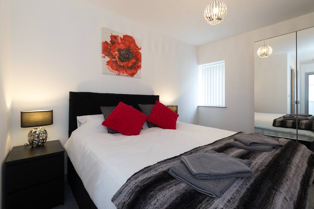 Bedroom 1, Double bed, mirrored wardrobe, 2 bedside chest of draws, 2 bedside lamps.