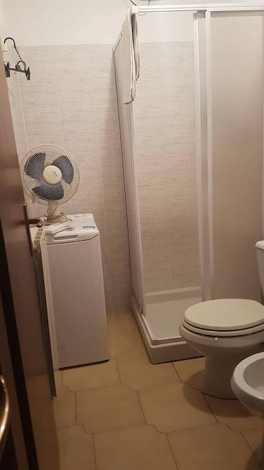 bathroom with shower and wash machine