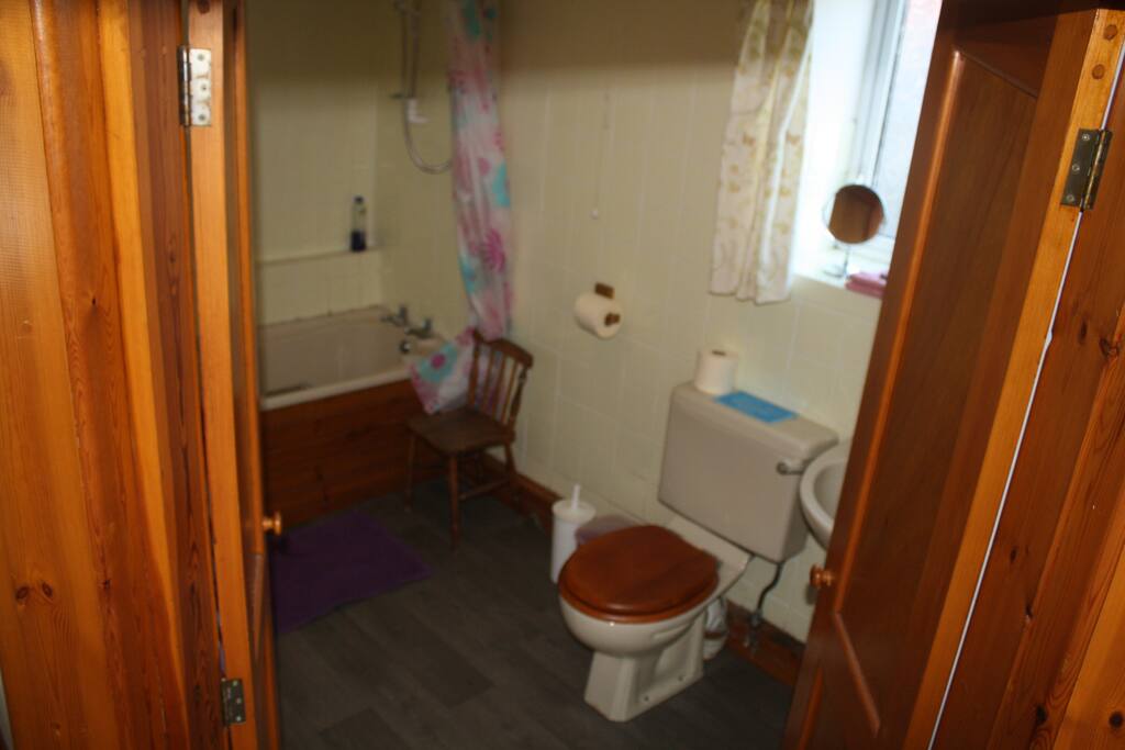 bathroom with bath and a shower