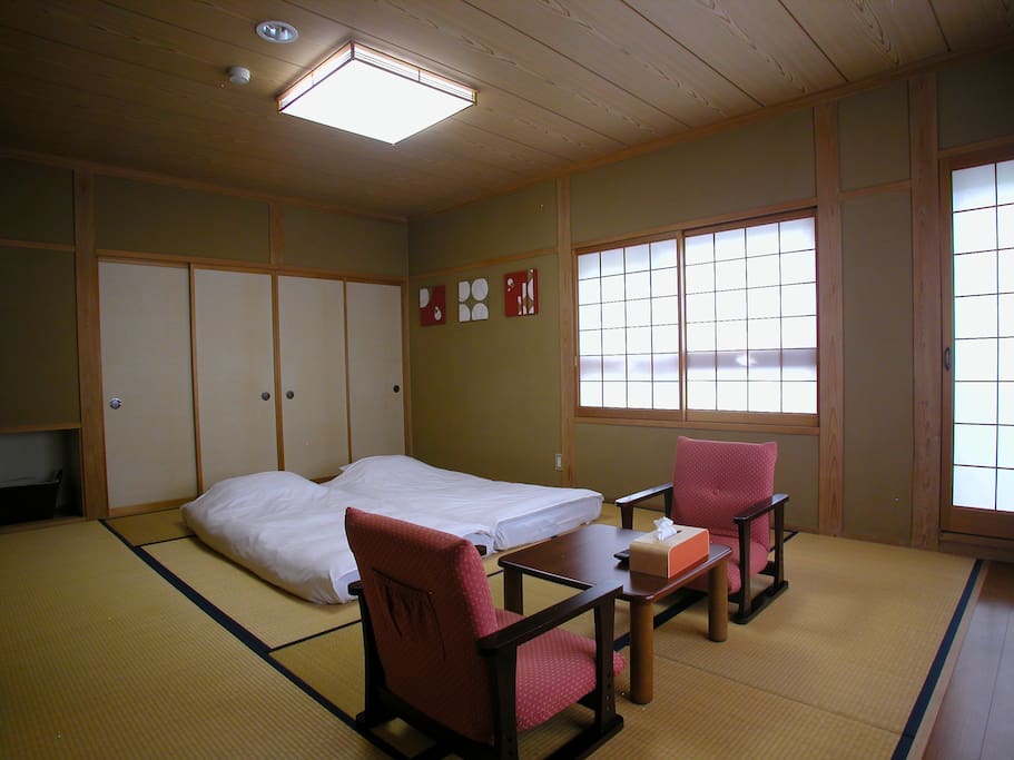 Traditional Japanese room w/ tatami floor, futon beds and shoji window blinds