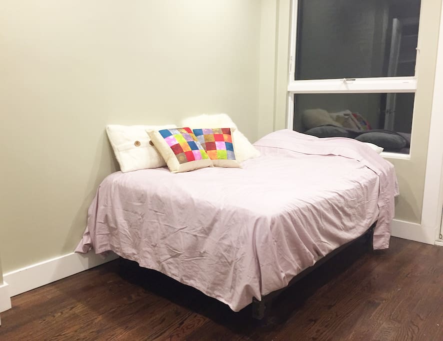 Your bedroom with full sized bed for two and a private balcony.
