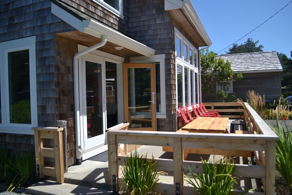 Front porch with picnic table and 6 outdoor chairs with french door into the house