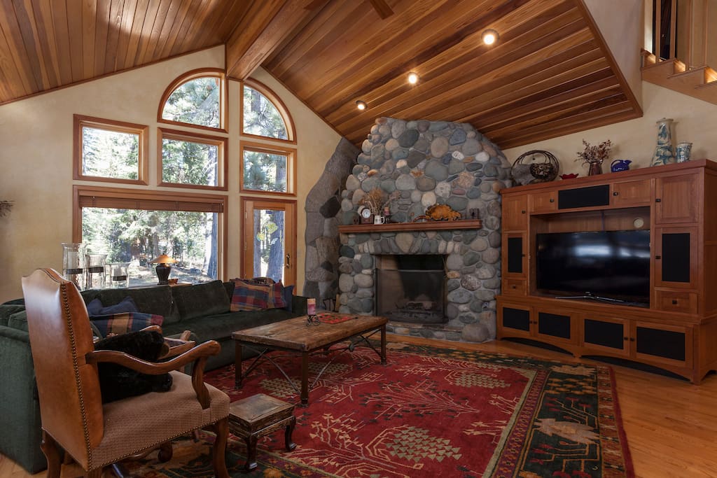 River rock surrounds a large wood fireplace