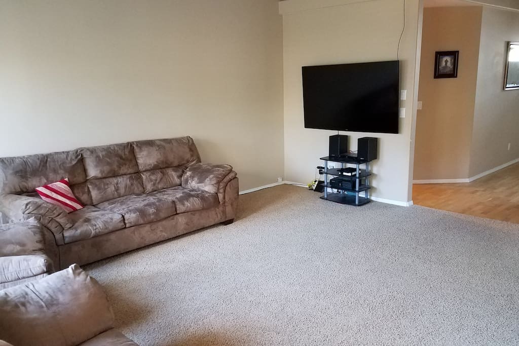 Living room with a 65 inch Smart TV with Hulu, Netflix and more. Also Blu-Ray player available.