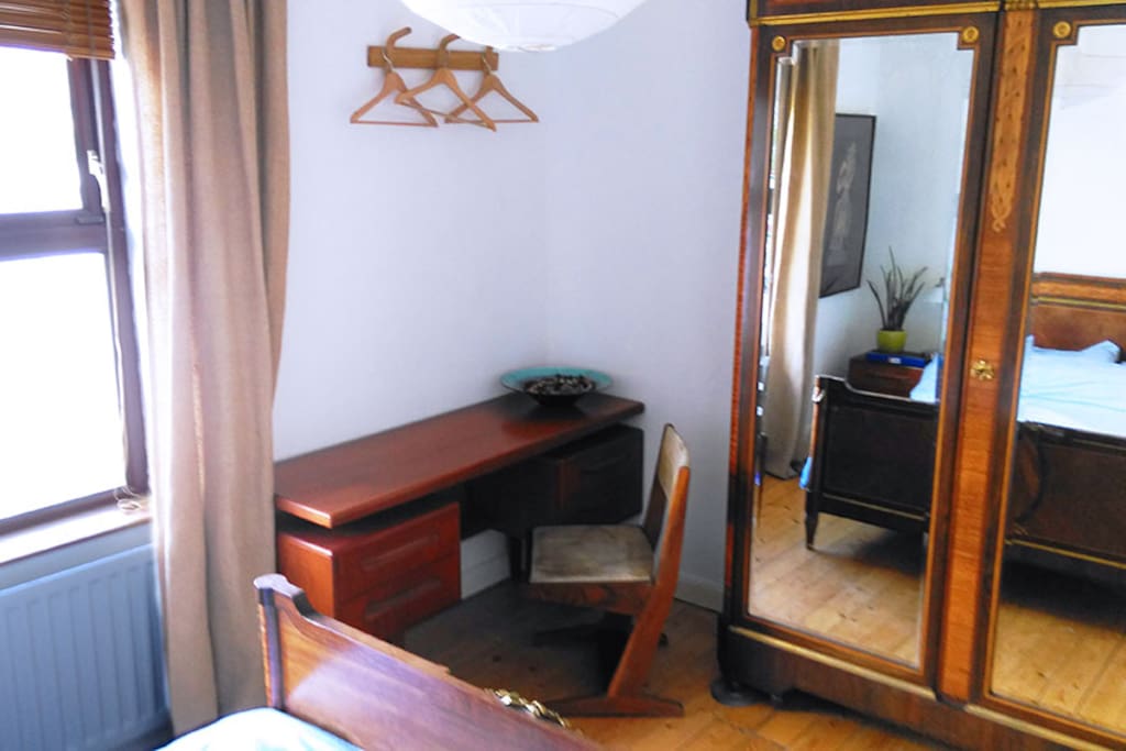 Bed: writing desk & antique linen press (shelving)