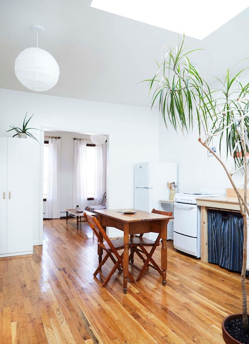 The bright and open main room includes a sitting area, dining area and kitchen