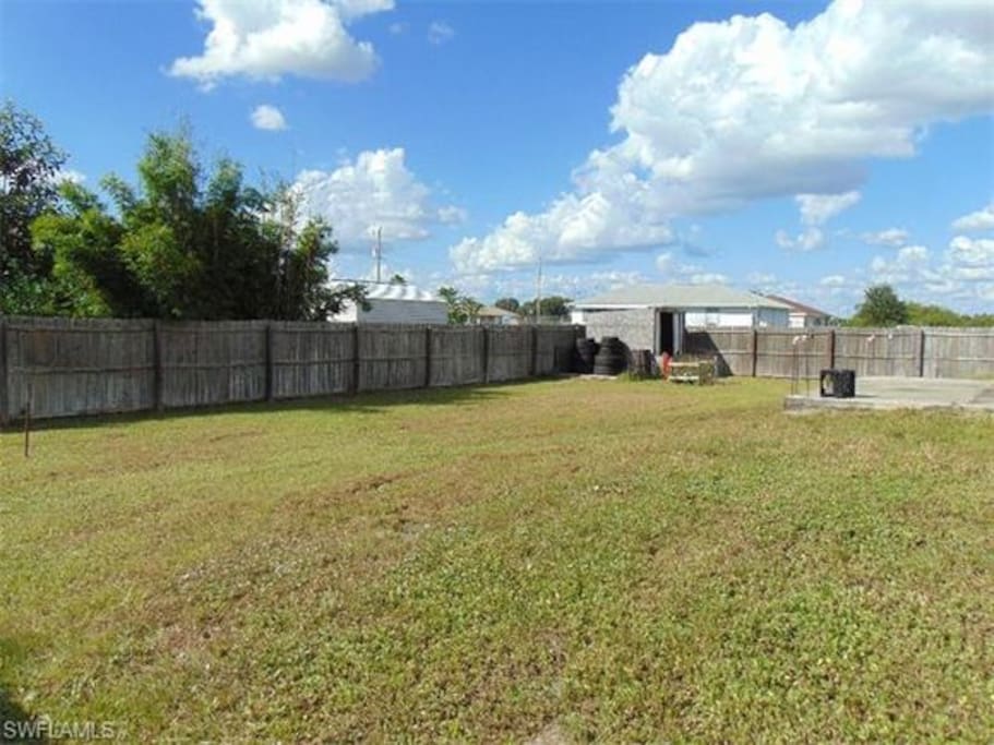 Spacious backyard with open patio, great for entertainment!