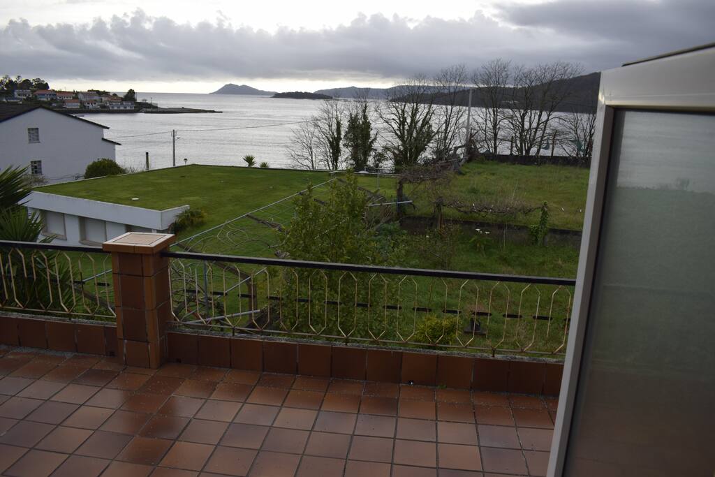 Terraza con toldo y mesa para comer fuera, viendo el mar