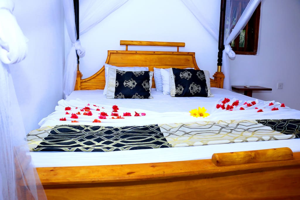 Large double bed with a mosquito net