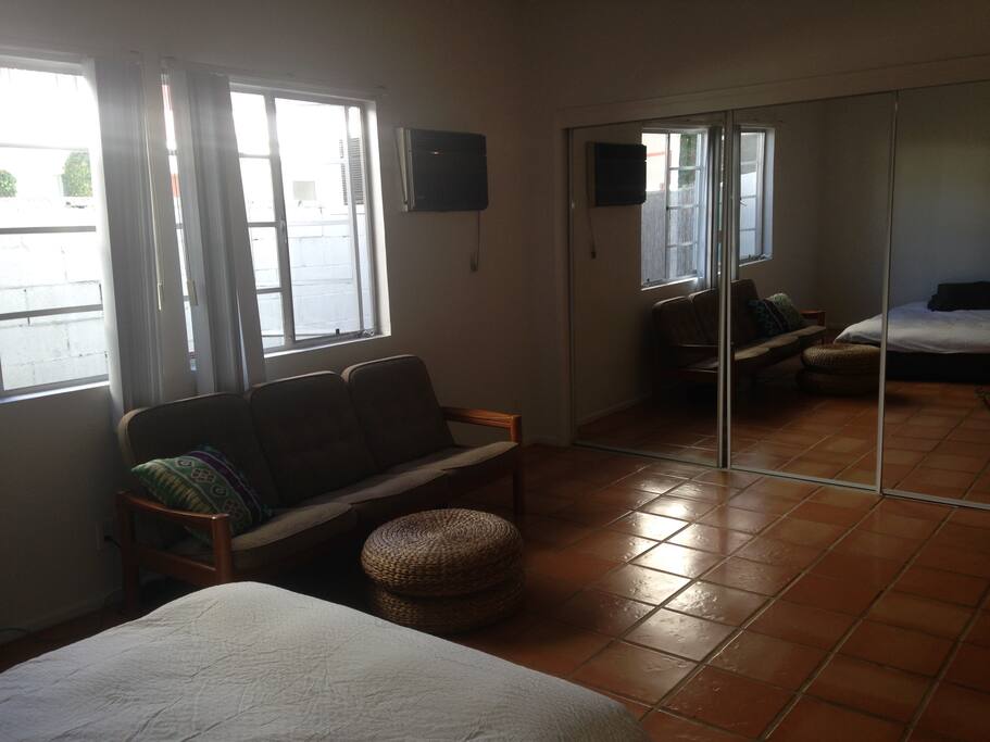 Mid-century Danish couch, tile floor, sliding glass closet.
