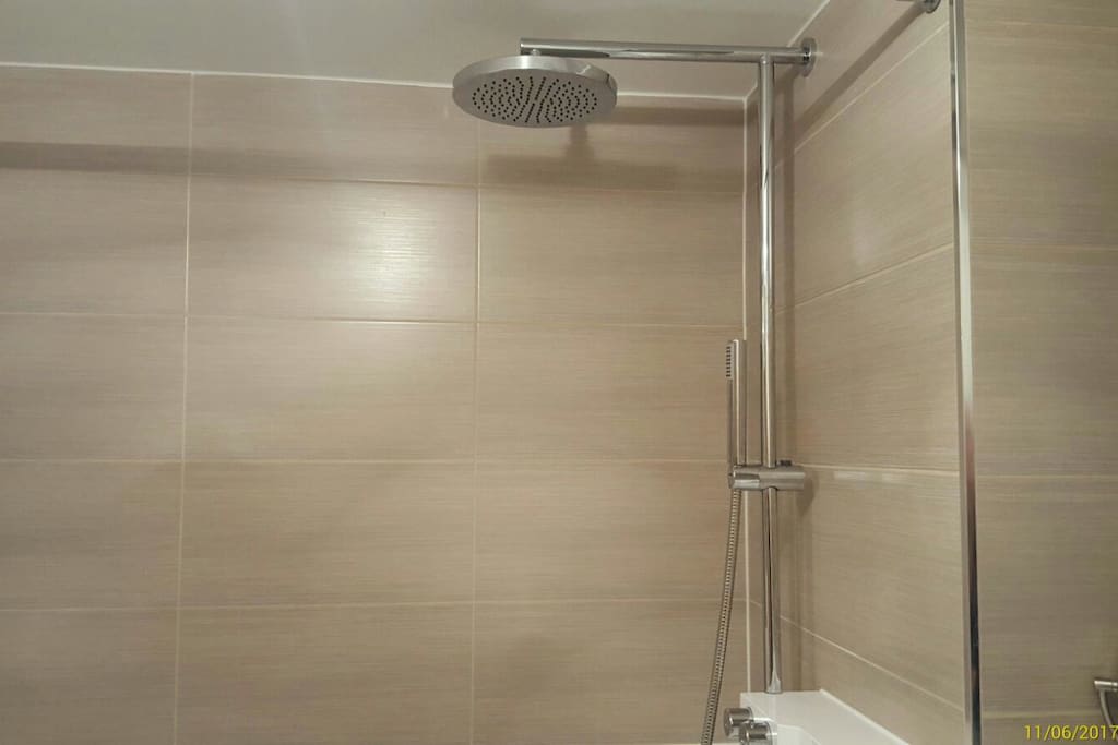 Great overhead shower with strong hand held shower and good sized bath