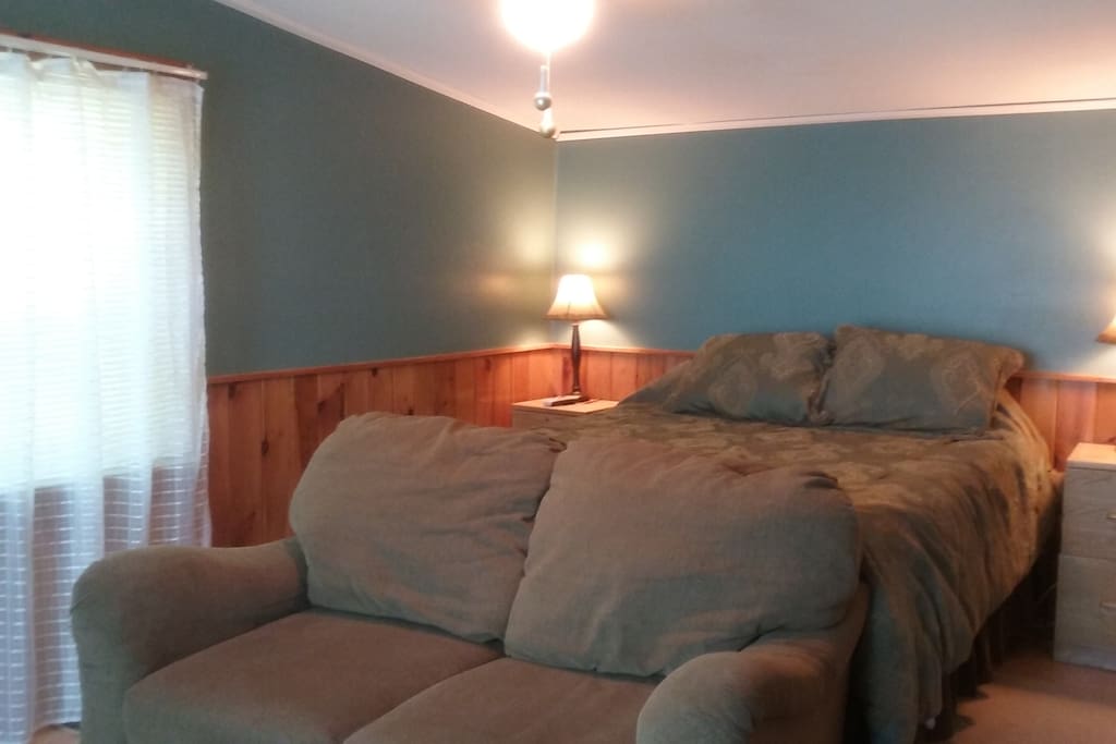 Your private bedroom with loveseat, coffee table, tv and stereo.