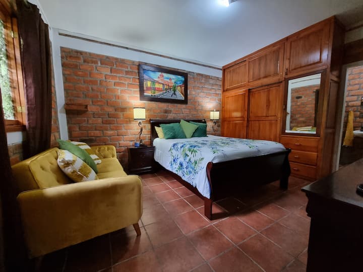 Chambre avec canapé-lit et lit queen.