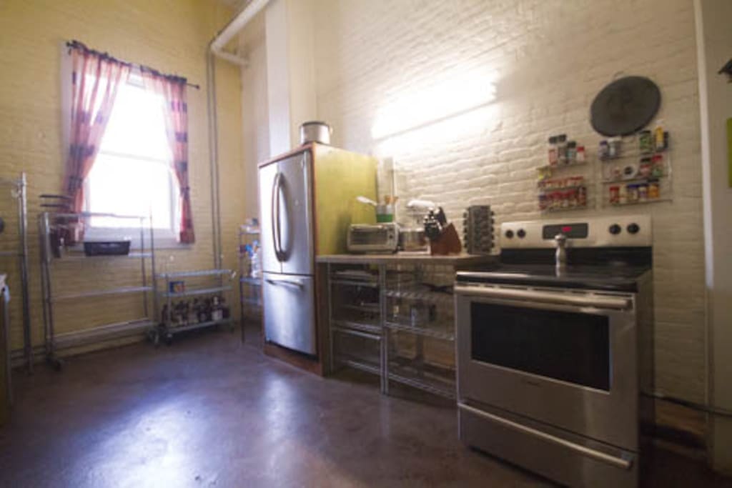 Full kitchen, featuring stove, oven, kitchen aid, confection oven, and dishwasher.