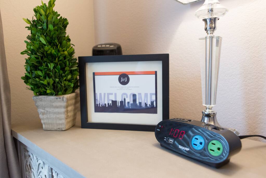 Nightstand in Guest Room with clock and plugs and usb port