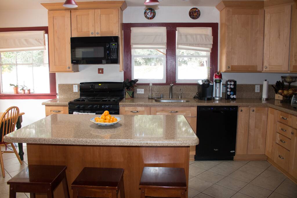 Kitchen with gas stove, dishwasher microwave, Keurig coffee maker and a soda stream.